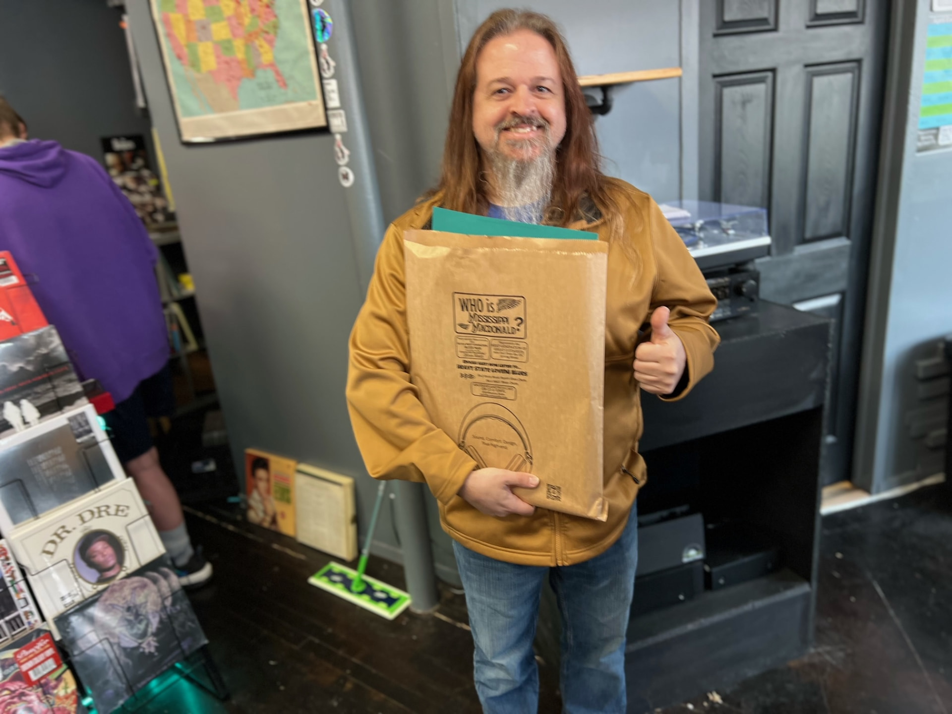 Customer giving a thumbs up with a printed kraft bag